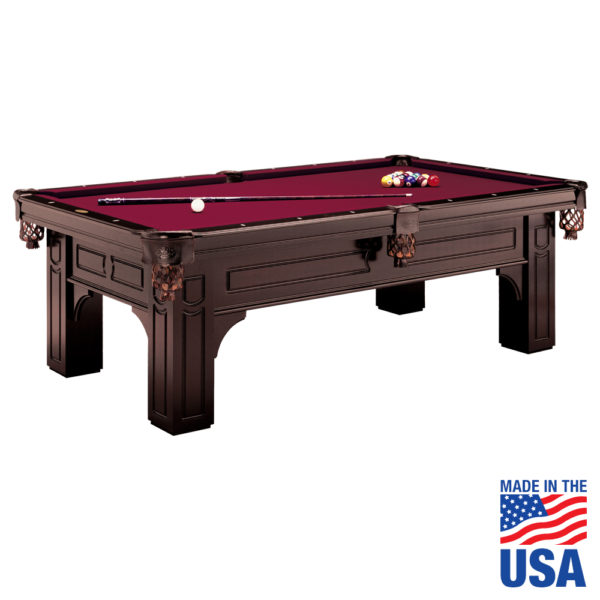 A pool table with red cloth and wooden frame.