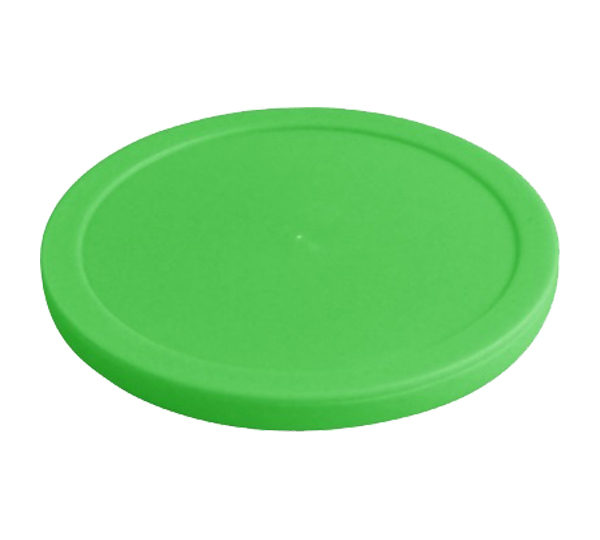 A green frisbee is sitting on top of a white surface.