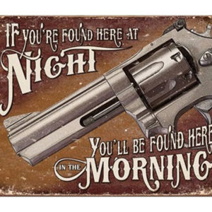 A metal sign with a gun and the words " if you 're found here at night, you 'll be found here in the morning ".