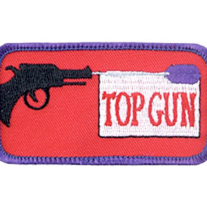 A patch with a gun and the words " top gun ".