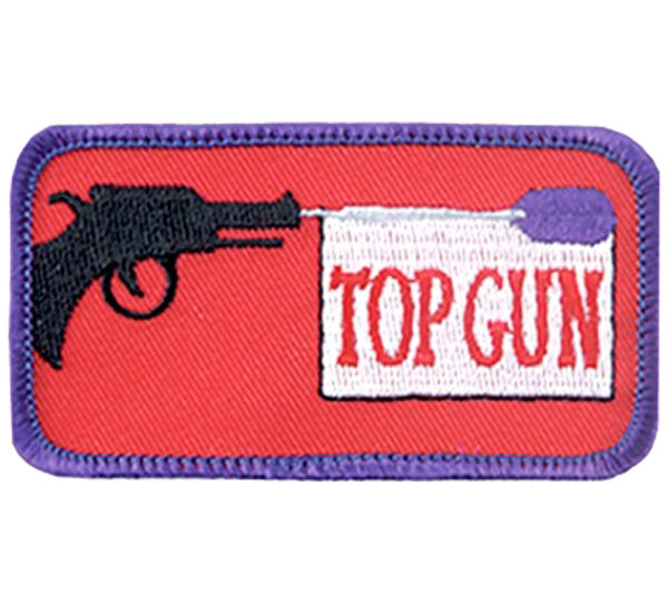 A patch with a gun and the words " top gun ".