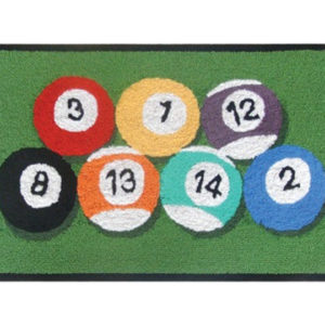 A group of eight pool balls on a green mat.