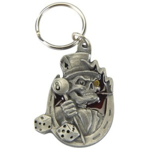 A metal key chain with a skeleton holding a dice.