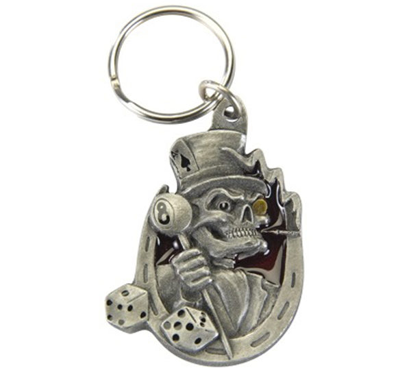 A metal key chain with a skeleton holding a dice.